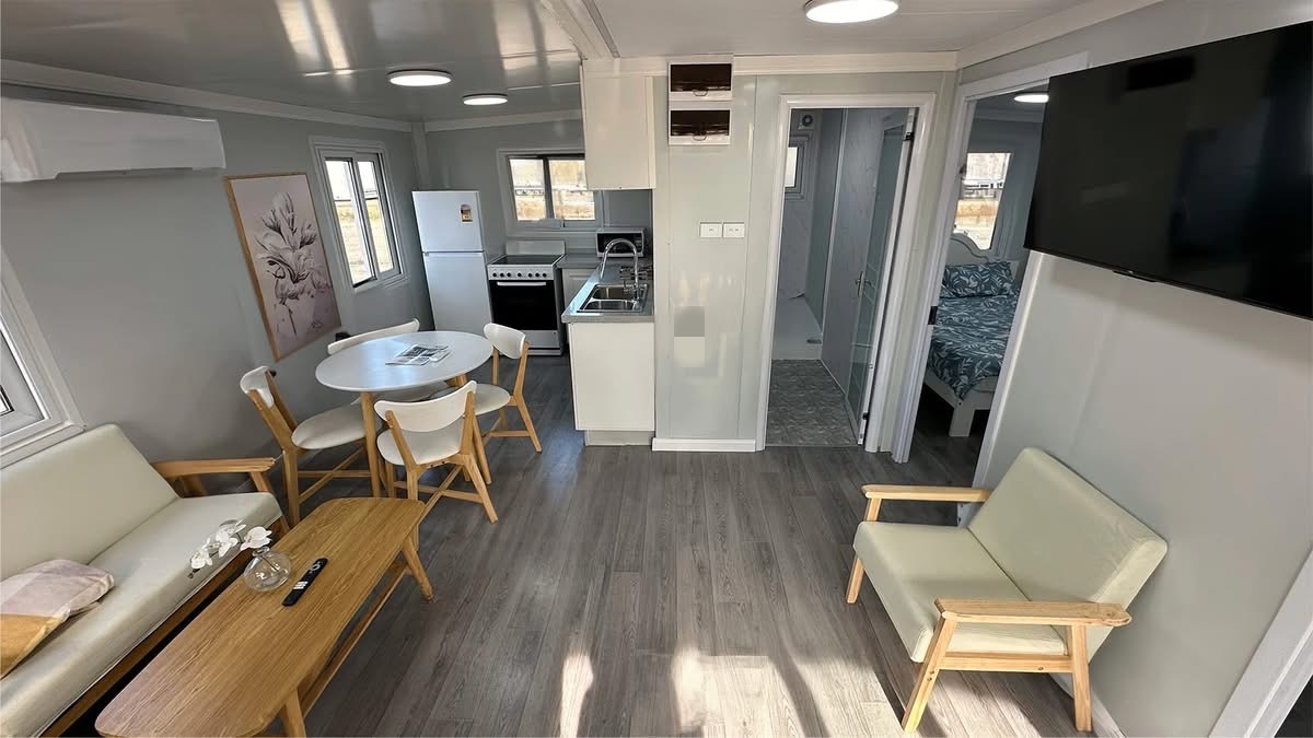 Interior view of bahria homes Castle Expandable House E20 featuring living room, dining area, kitchen, and bedroom in a modern prefab modular home