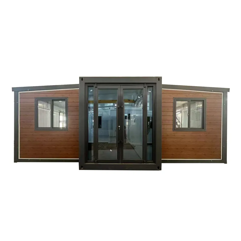 Front exterior view of bahria homes Castle Expandable House E20 featuring wood panel finish, glass doors, and modern prefab modular structure